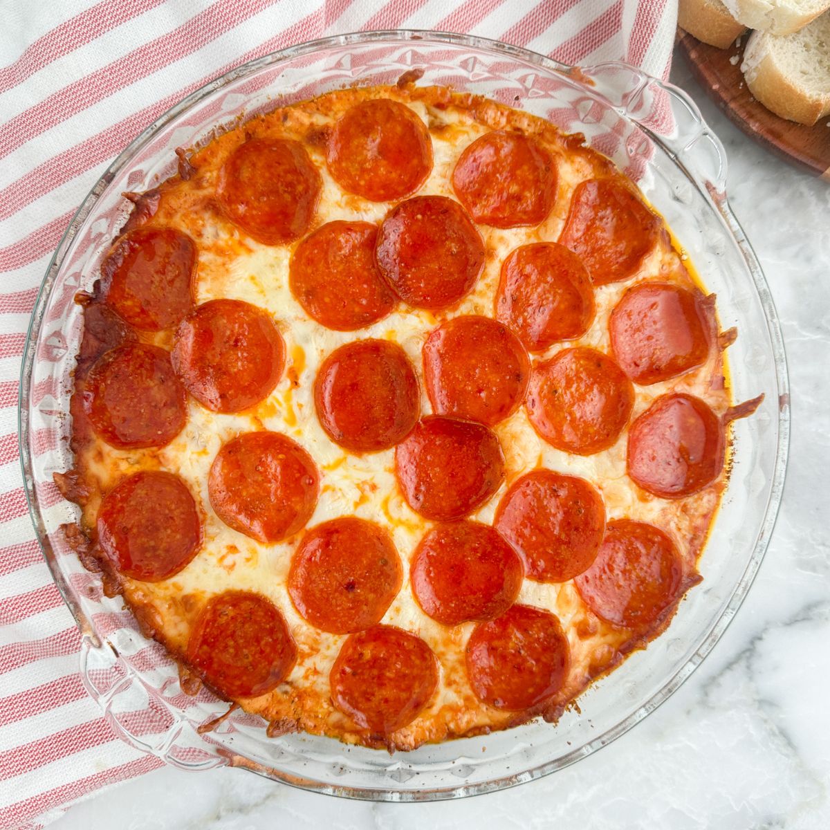 Cooked pizza dip in a pie plate.