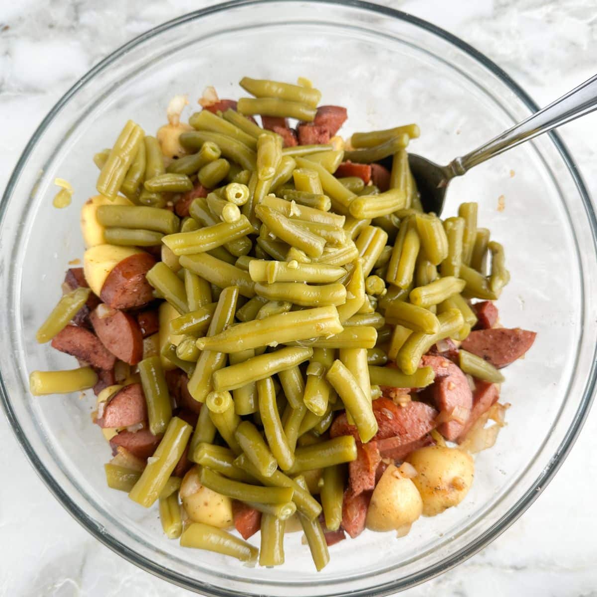 Bowl of potatoes, kielbasa, and green beans. 