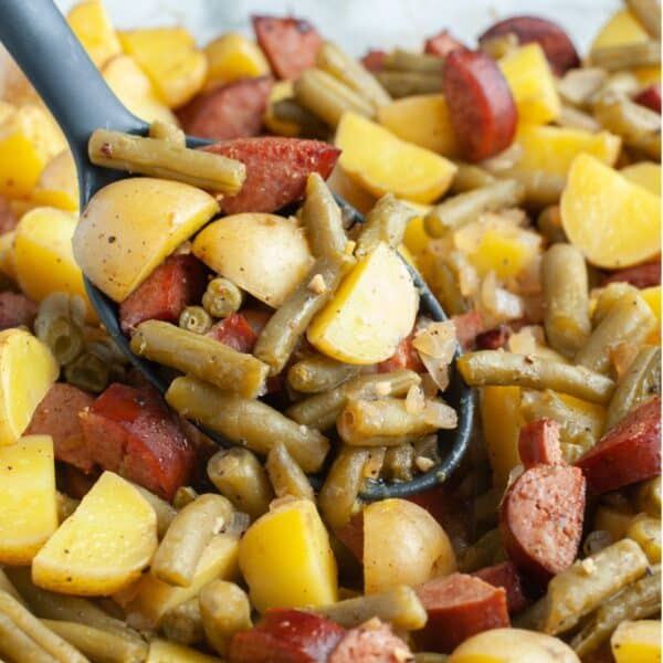 Sausage, green bean, and potato casserole in a spoon.