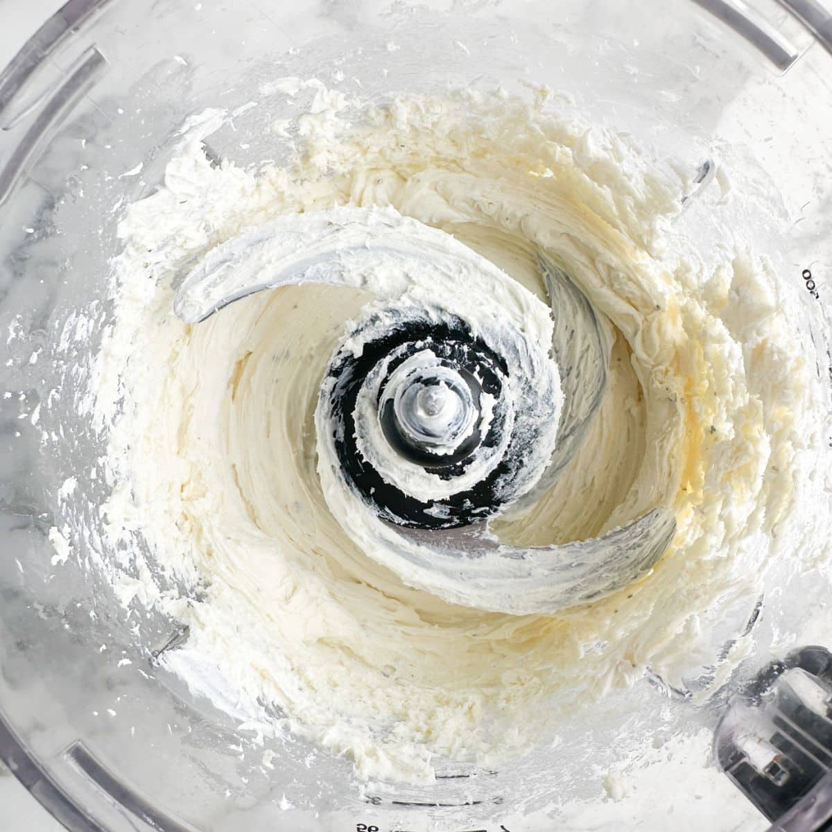 Whipped cream cheese in a food processor.