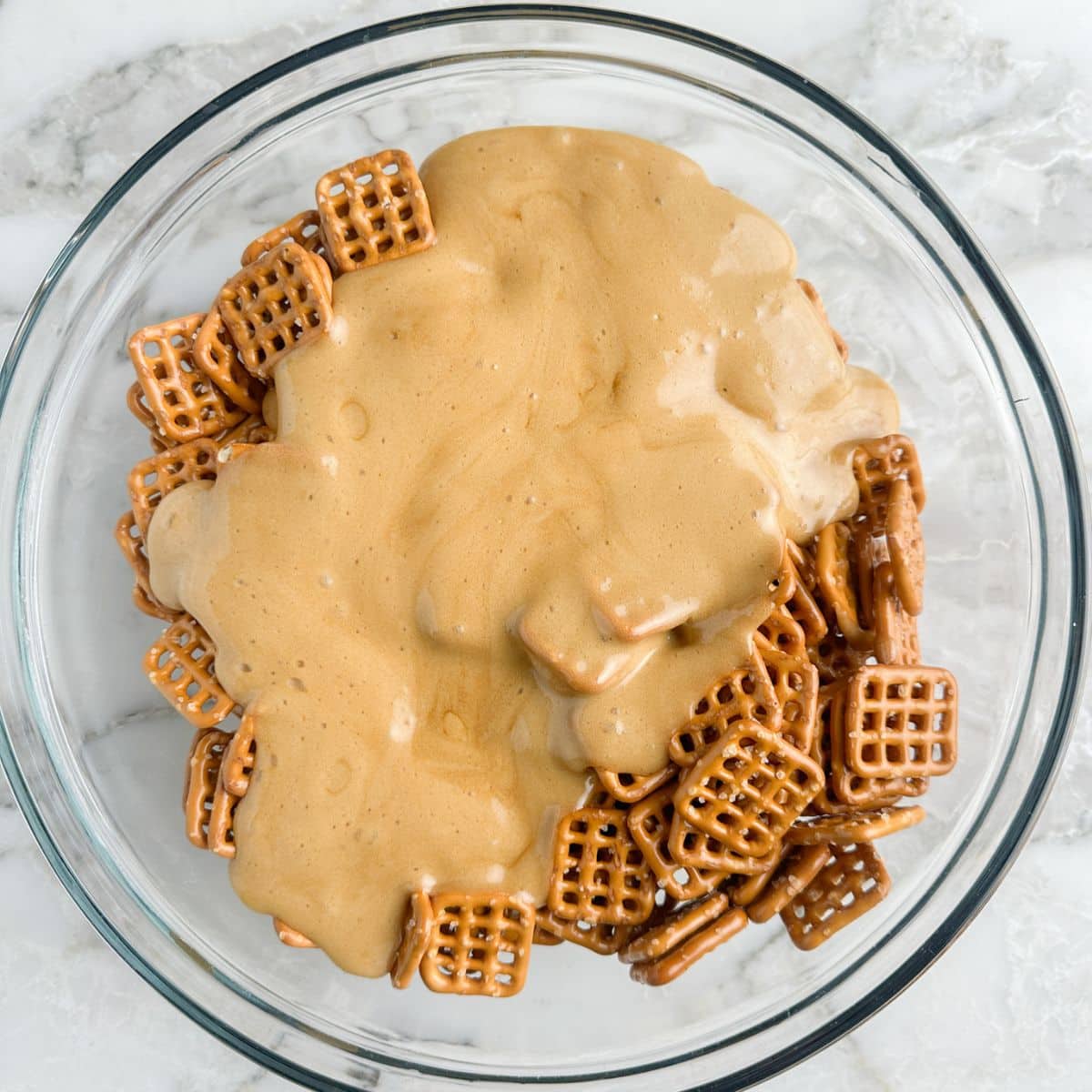 Bowl with pretzels covered in butter toffee sauce. 