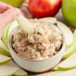 Bowl of toffee dip with an apple slice.