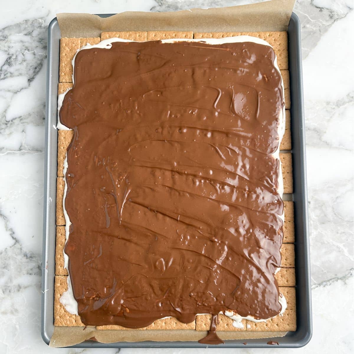 Smores bark on a baking sheet.