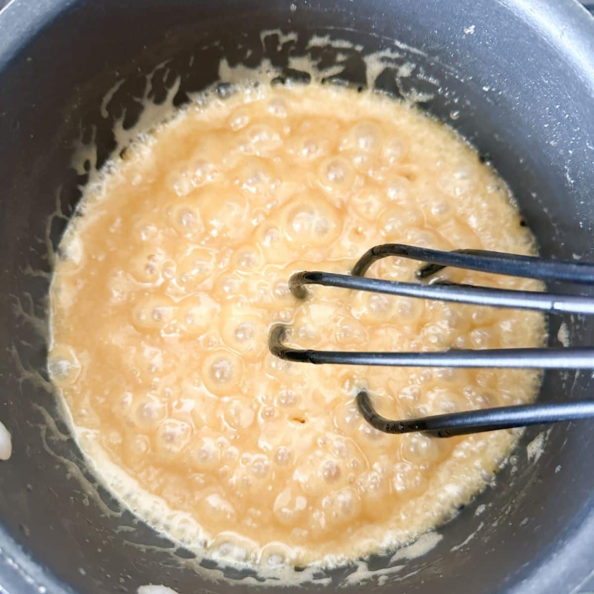 Pot with boiling brown sugar and butter.