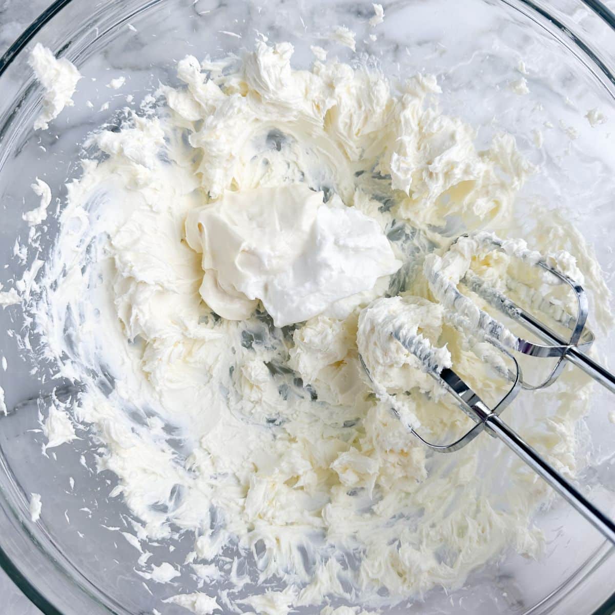 Bowl with whipped cream cheese, sour cream, and mayonnaise. 