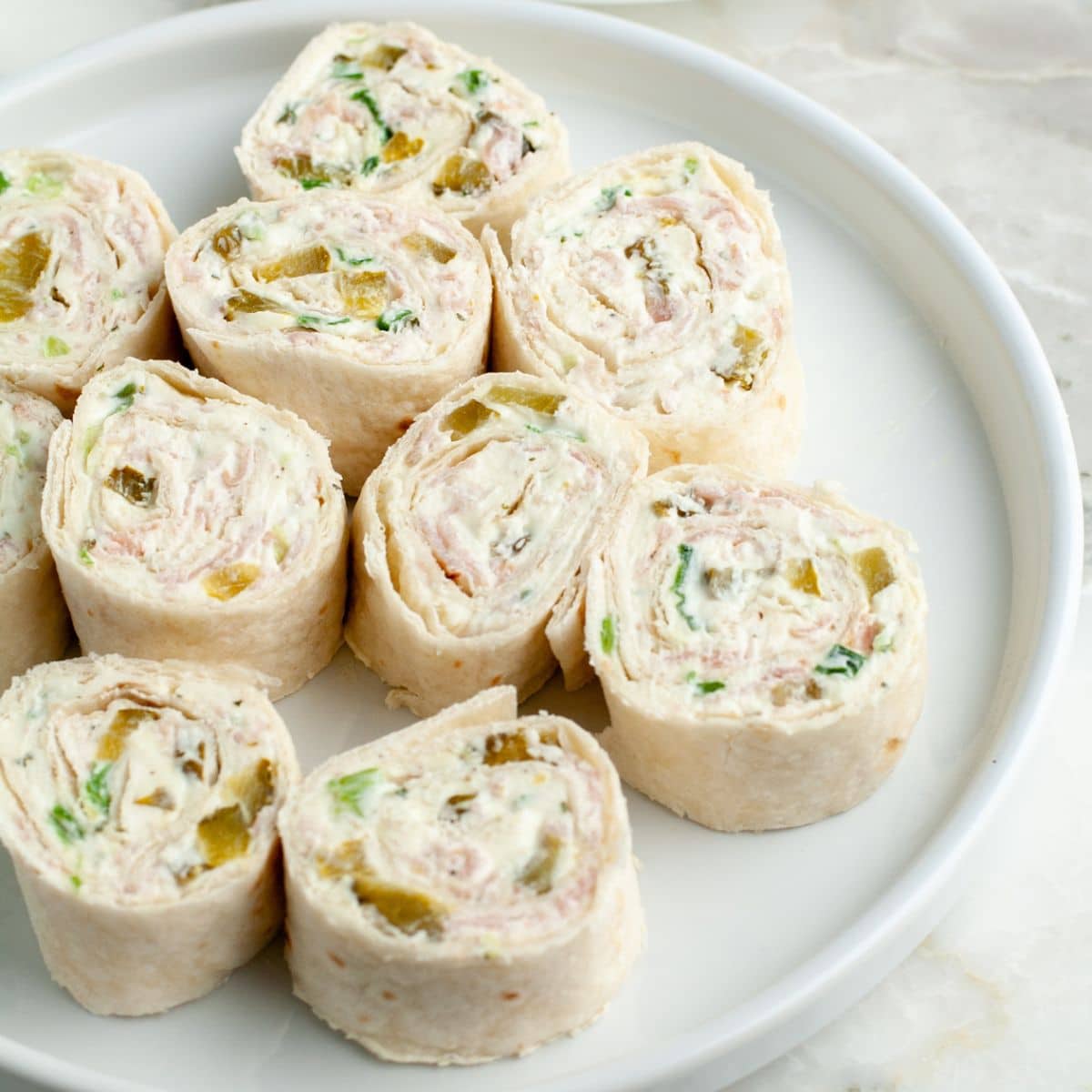 Plate with dill pickle pinwheels. 