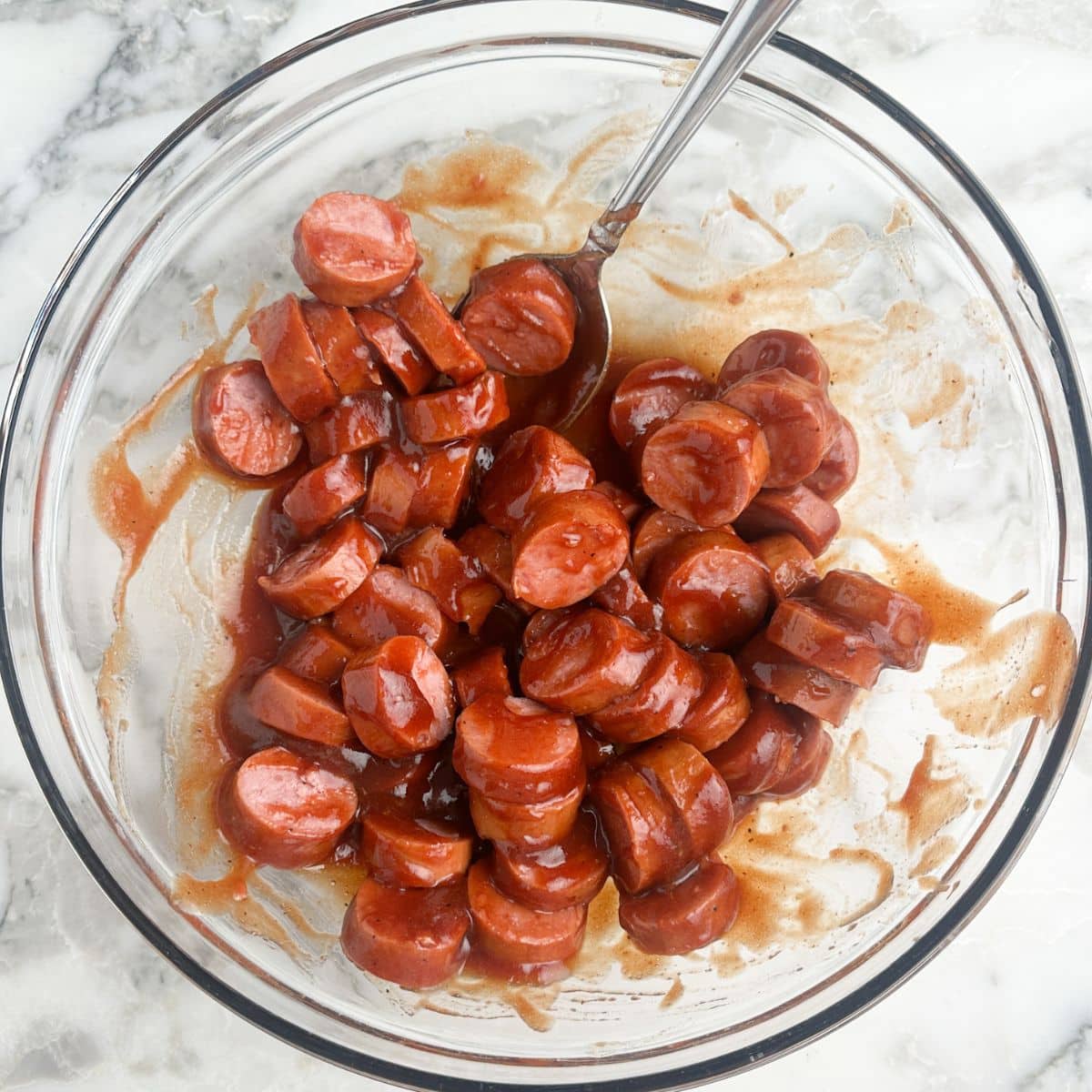 Bowl of kielbasa sausage with bbq sauce.