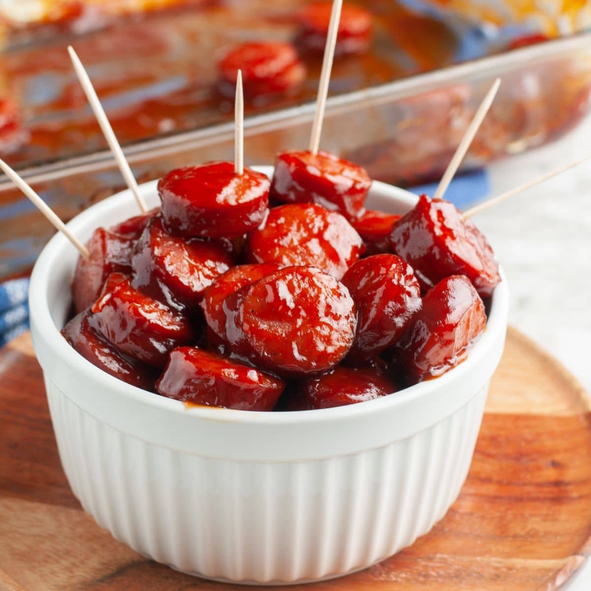 Bowl of BBQ sausage bites with toothpicks.