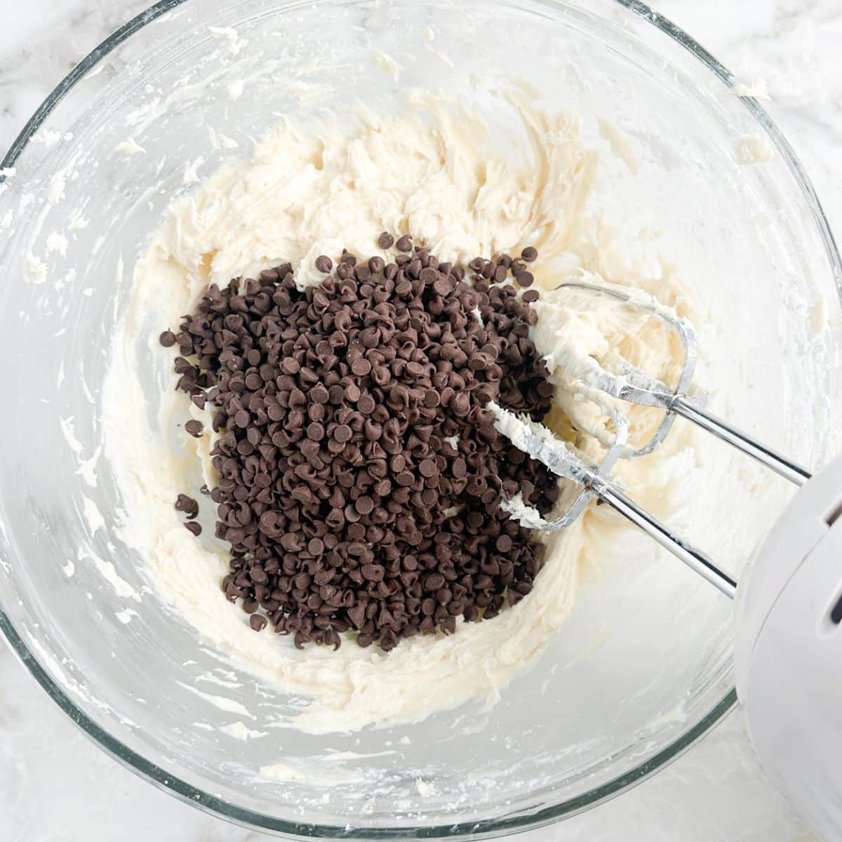 Bowl with whipped cream cheese and chocolate chips. 