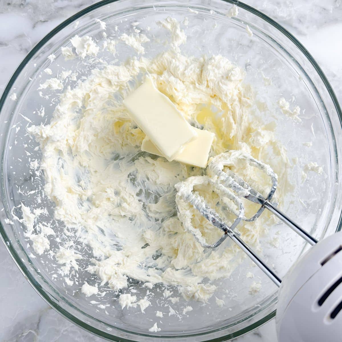 Bowl with whipped cream cheese and butter. 