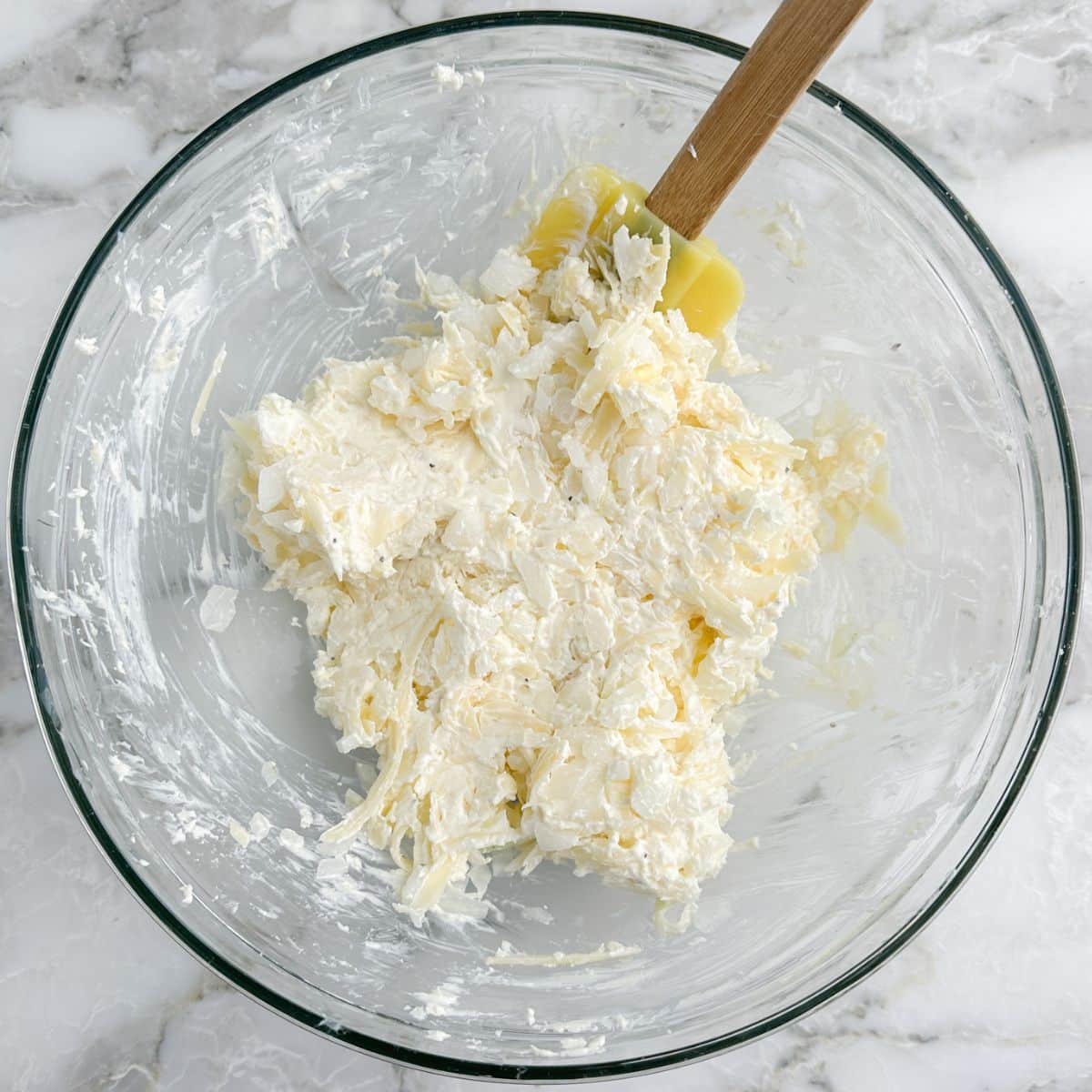 Bowl of onion dip with a spatula. 