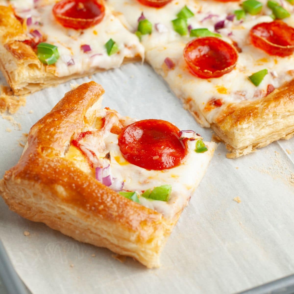 Puff pastry pizza on a pan.