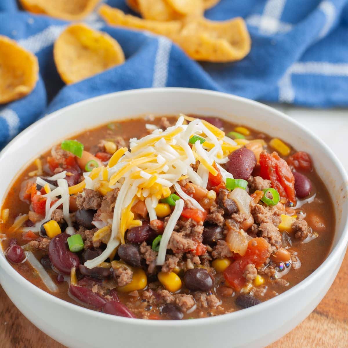 Bowl with bean soup topped with cheese. 