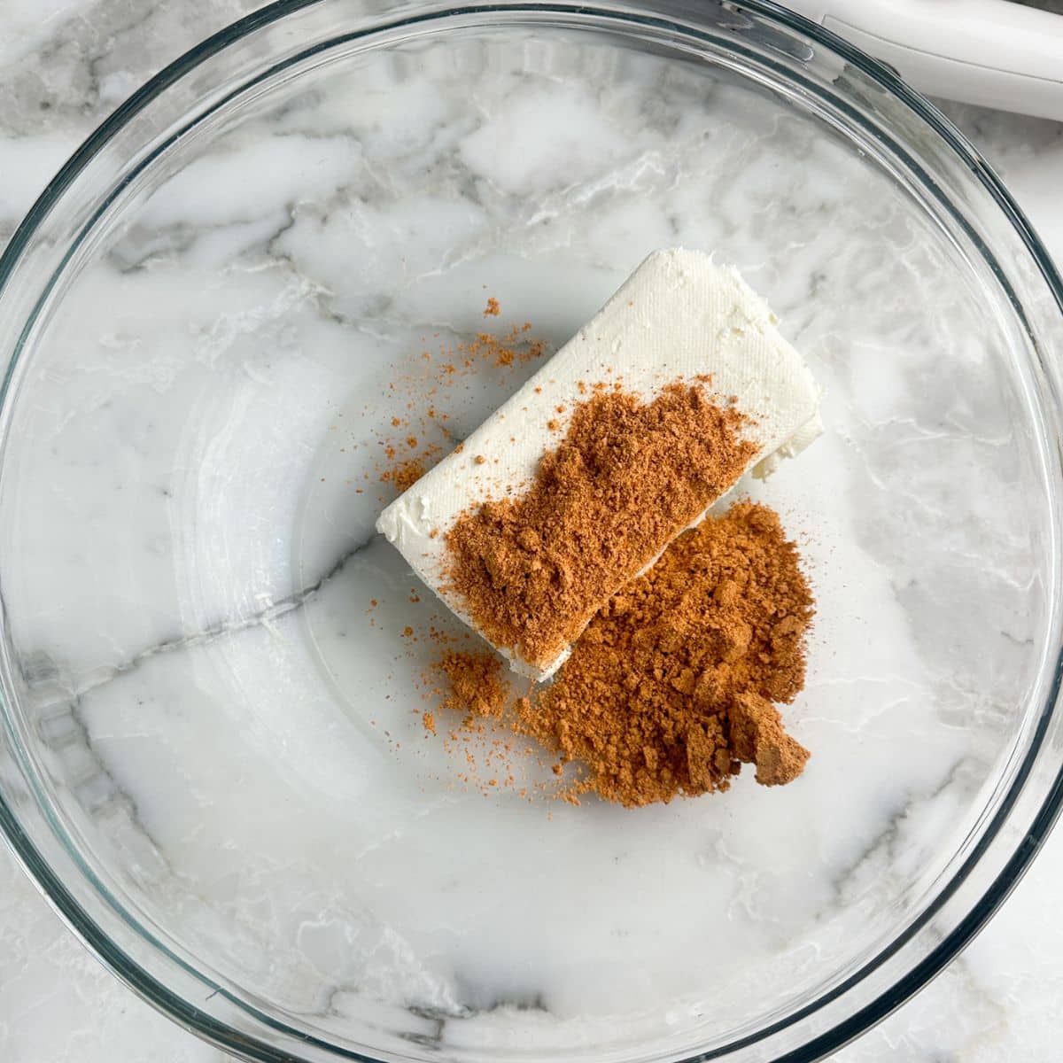 Bowl with cream cheese and taco seasoning. 