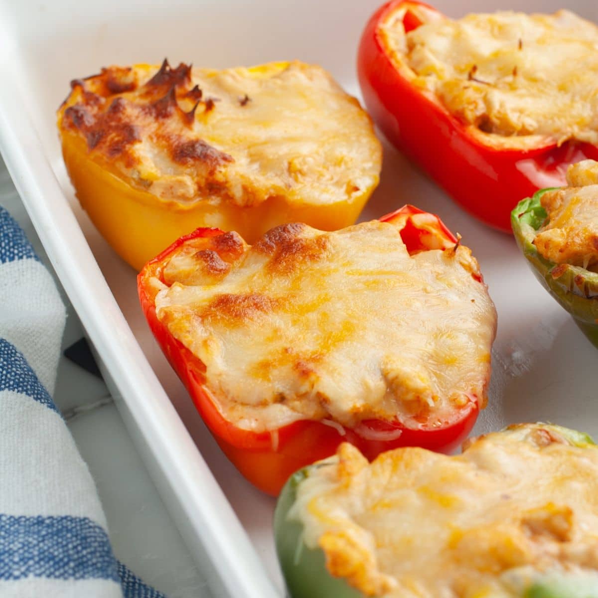 Bell peppers stuffed with chicken and melted cheese.