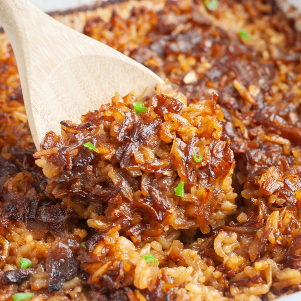 Wooden spoon with onion rice. 