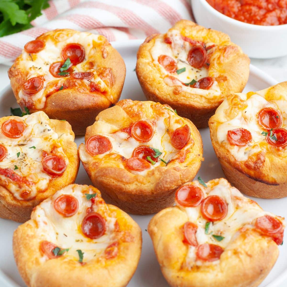 Plate of pepperoni pizza cupcakes. 