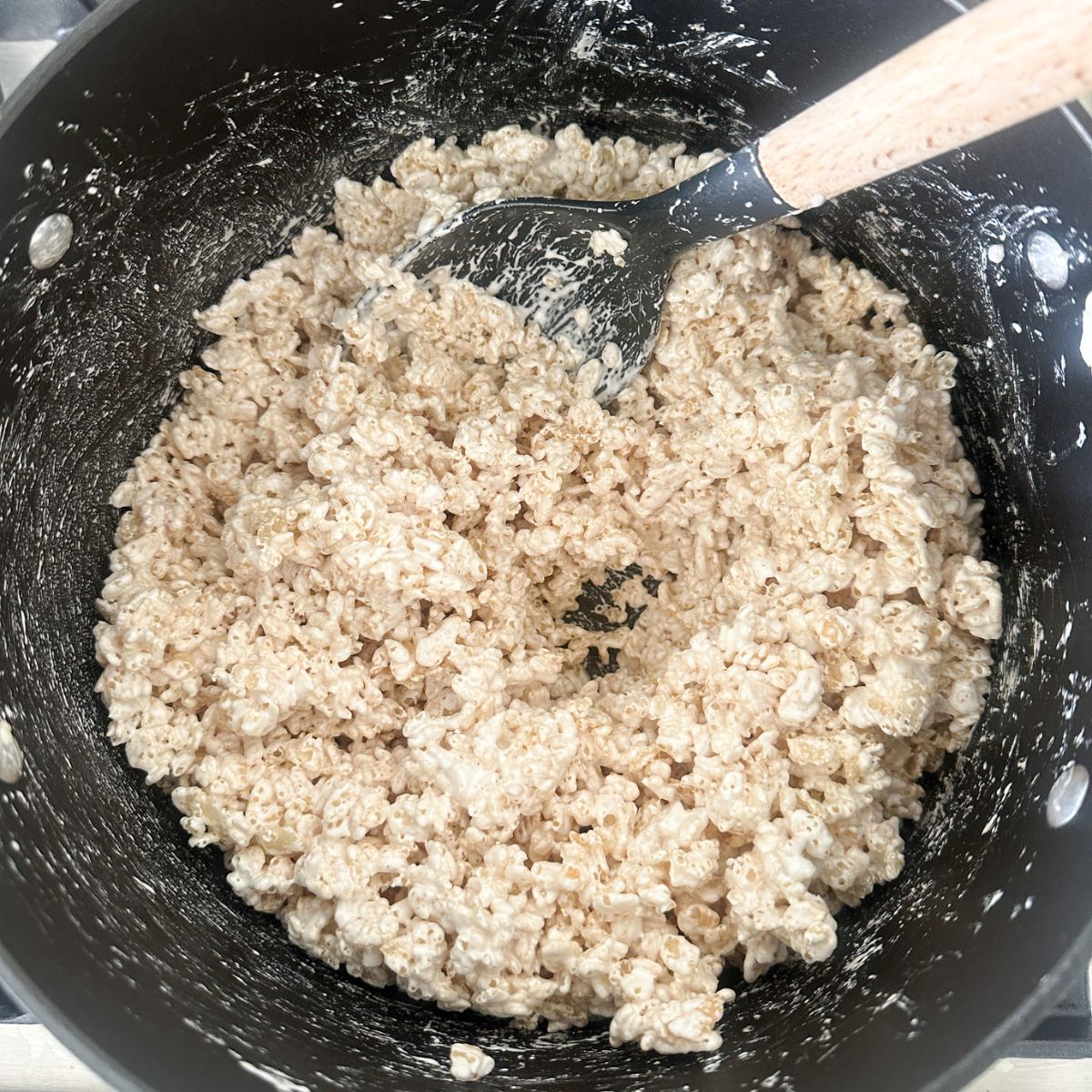 Pot with melted marshmallow fluff and rice krispies.