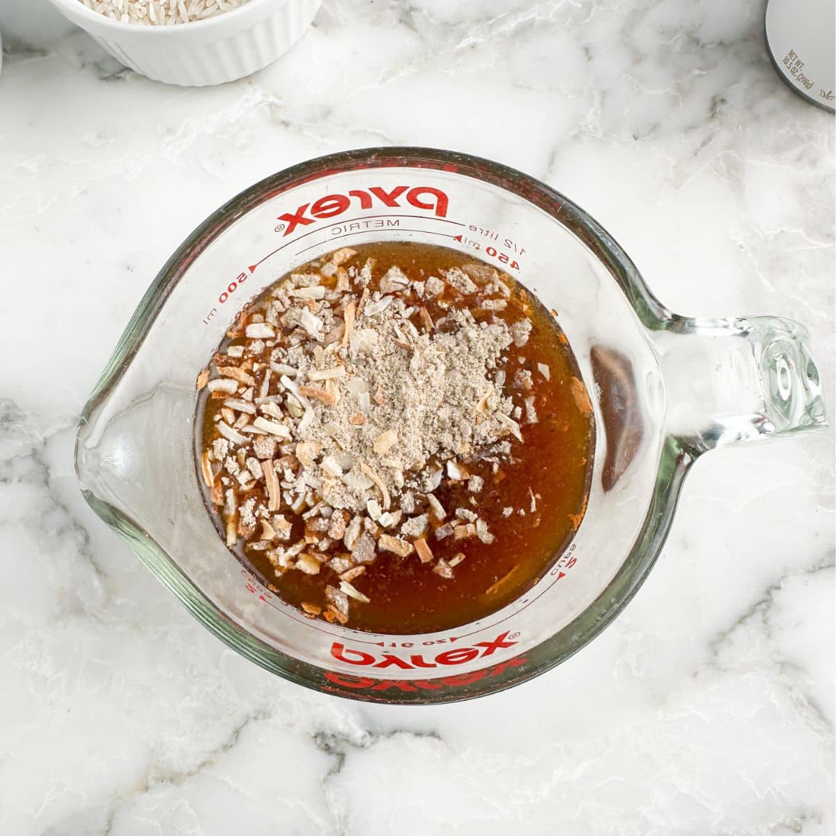 Measuring cup with beef broth and onion soup mix. 