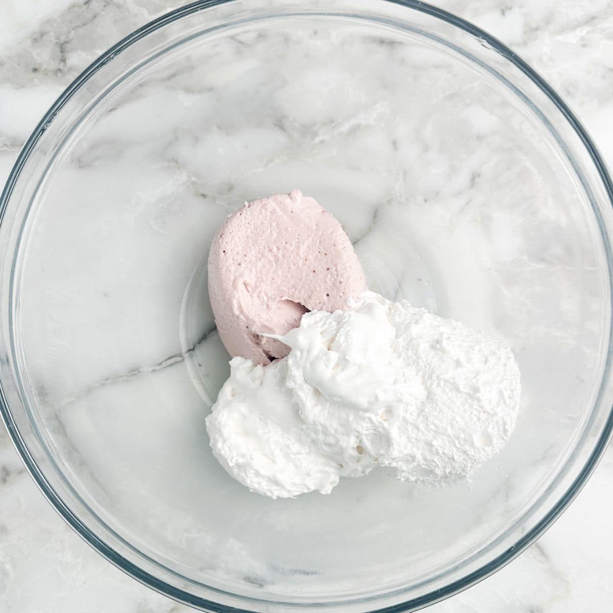 Strawberry cream cheese and marshmallow fluff in a bowl. 