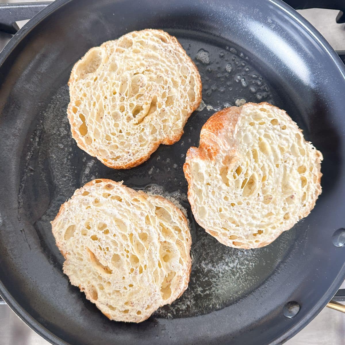 Skillet with uncooked french toast.