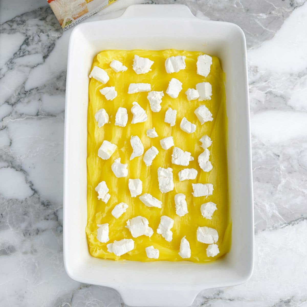 Baking dish with lemon filling and cream cheese. 